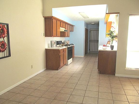 LIVING AREA WITH VIEW OF KITCHEN AND ATRIUM