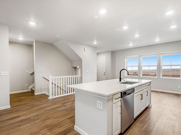 Kitchen overlooking dining and stairs to full finished basement