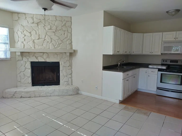The dining room and kitchen. The dining room has a door that goes out to the backyard.