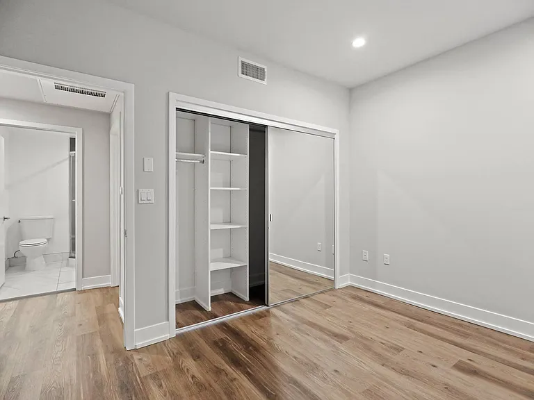 Bedroom with Mirrored Closet with Shelving