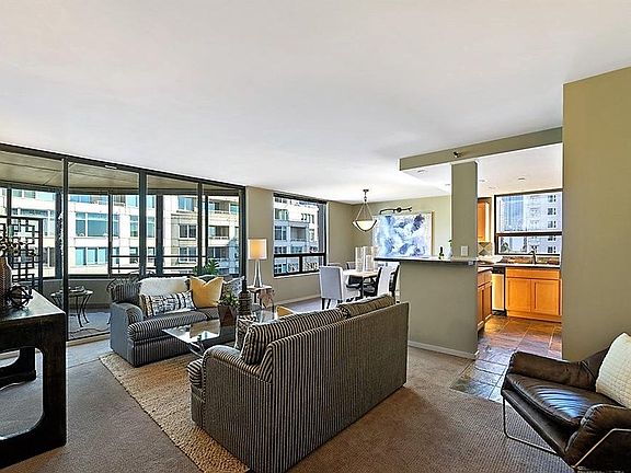 View of living area, kitchen & dining area from unit 702 entry.