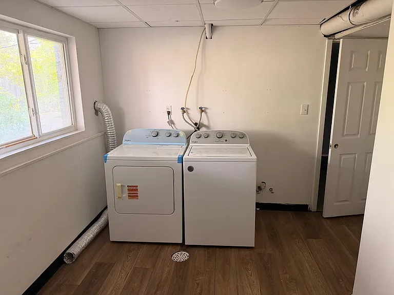 Dedicated laundry area with side-by-side washer and dryer, convenient hookups, and a window for ventilation.