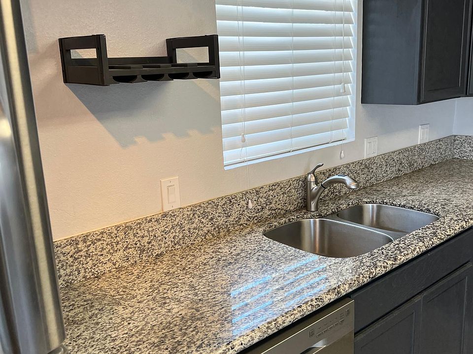 Kitchen sink with wine glass holder on wall