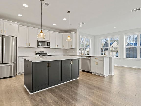 The kitchen and sunroom in the Summerfield on homesite 1062 at Lakeside at Trappe by Brookfield Resi