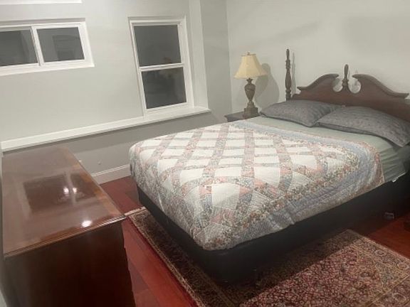 Furnished bedroom with windows