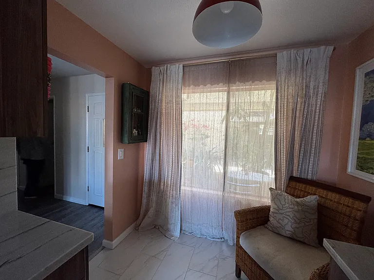View from kitchen toward front door (on left side of picture) and external window (facing condo courtyard).