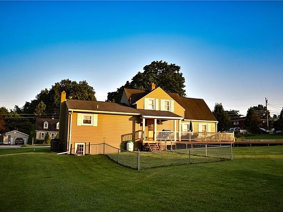 Rear of home - nice wrap around deck and fenced in area to keep your four legged loved one safe!