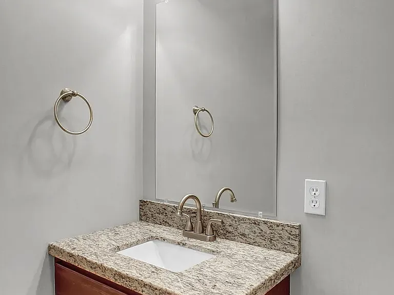 Half bathroom that is off the living room on the 1st floor.