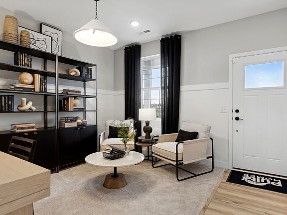 The foyer greets you with a wide open flex room