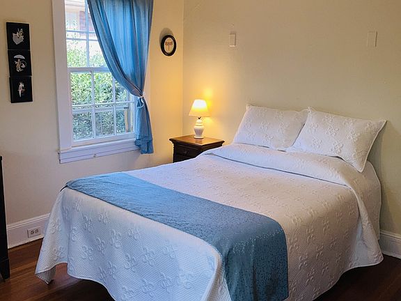 Front bedroom with queen bed, 2 mahogany dressers and matching end table, one closet