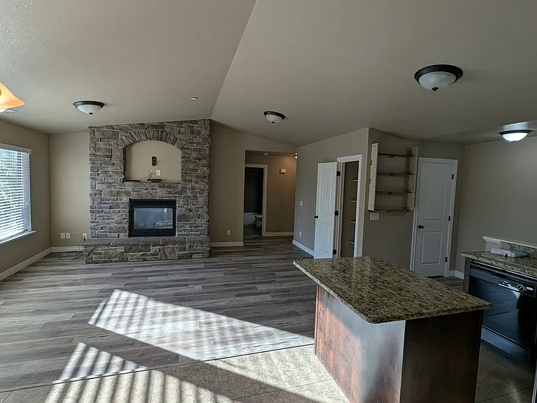 Great room with fireplace and vaulted ceilings from the dining room