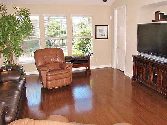 GREAT ROOM VIEW FROM FRONT ENTRY - LOADED WITH NATURAL LIGHT - WOOD FLOORS & 2-STORY CEILING.
