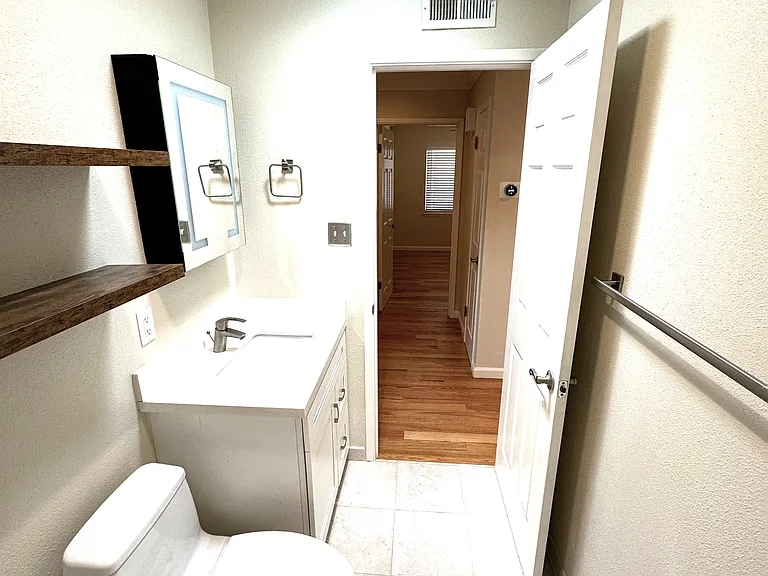 Hall bath with shower over tub