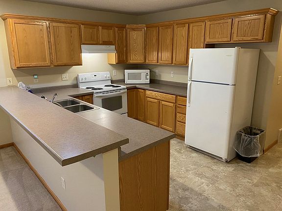 Kitchen w bar counter, opens to living / dining