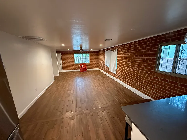 Great family room with exposed brick wall