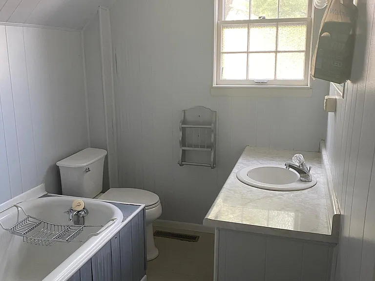 Upstairs bathroom. Large deep bath tub. Has large vainty with storage.