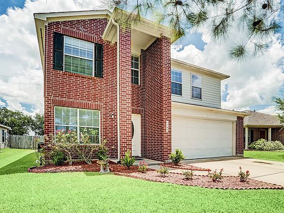The home has two story covered brick entry with pillar. Home has never flooded and is in a low tax area that backs up the Fort Bend County Fairgrounds.