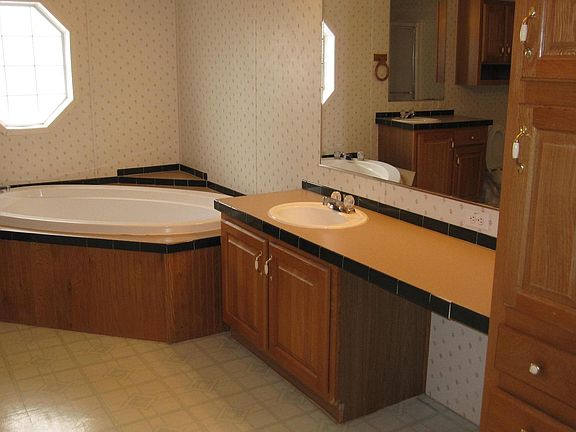 Huge Master Bath! You can see one vanity next to the garden tub, and the other vanity reflected in the mirror.