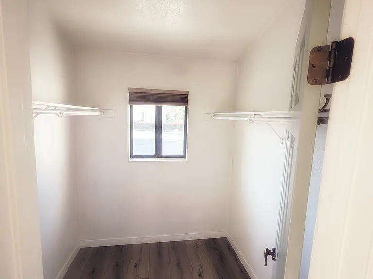 Walk in closet in primary suite.