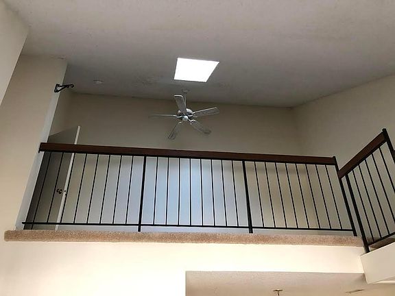 loft with ceiling fan