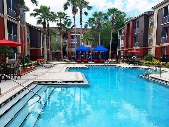Image of one of the two resort-style swimming pools with a lounge chair seating area.
