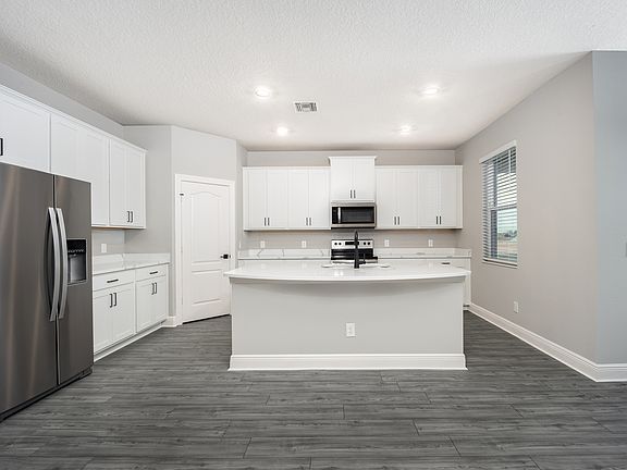 The kitchen has a beautiful quartz island.