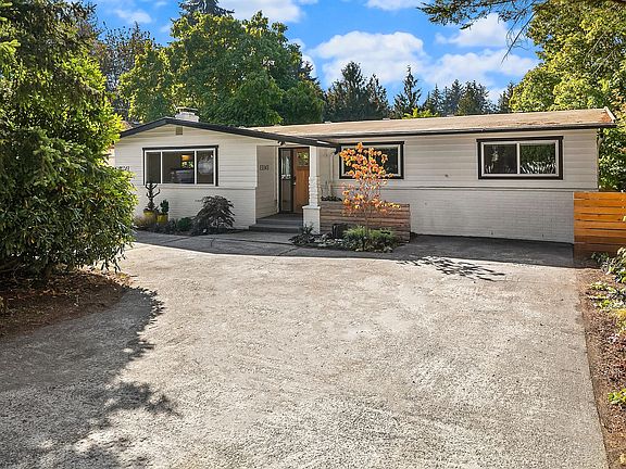 Home sits back from the street behind a hedge.