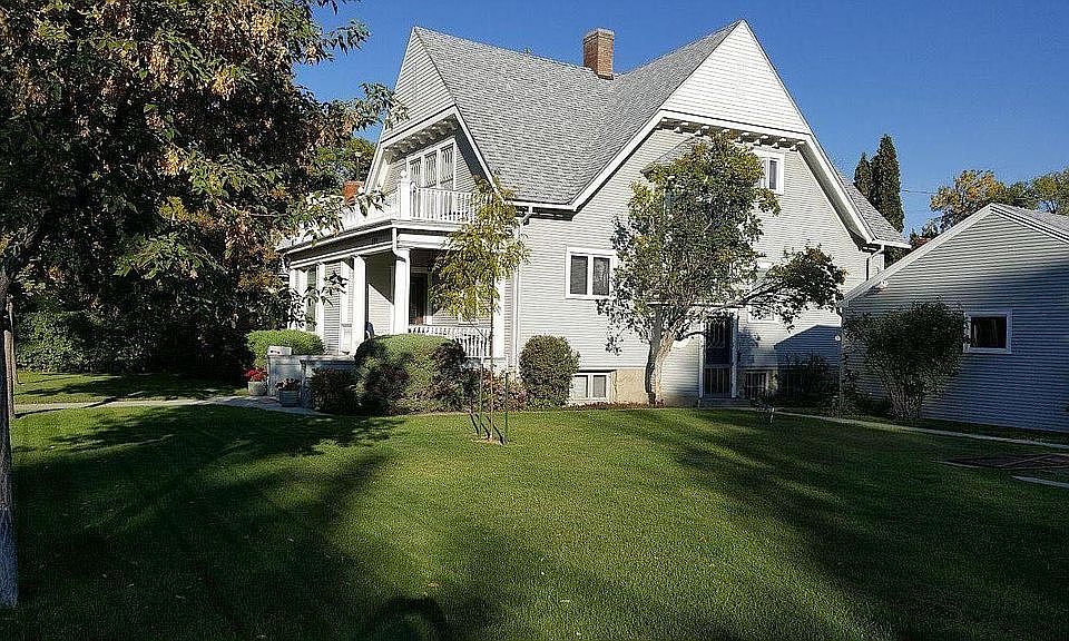 Outside of the home in summer. The detached garage is on the right.