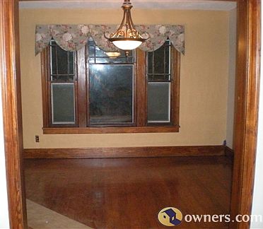 Living room with vintage windows, trim and re-finished wood flr