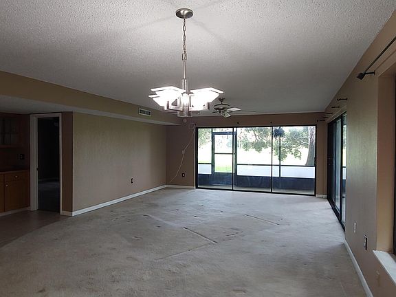 Living room from kitchen. Master BR door to the left, dining room in foreground.