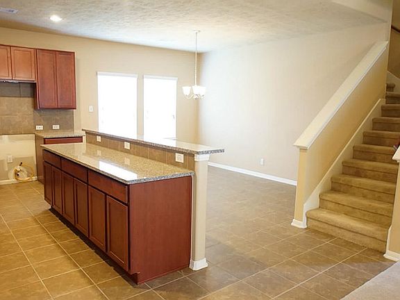 Granite island provides additional counter and cabinet space.