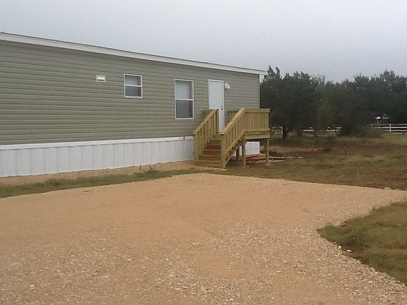 rear of the home with drive