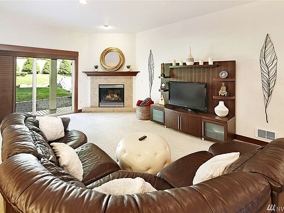 Spacious living room with gas fireplace that opens to covered back deck.
