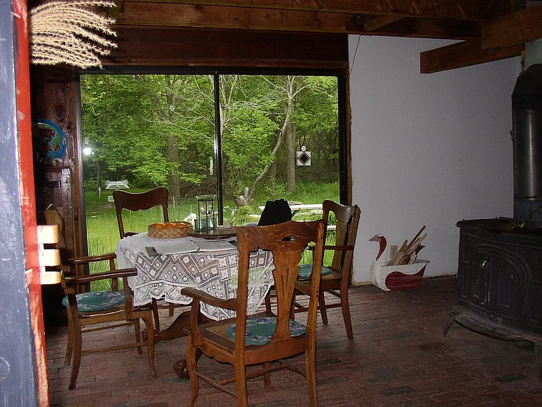 Brick floor of kitchen. Wood stove replaced with propane gas fueled stove.