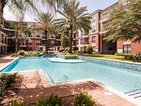 Resort-Inspired Pool with Sun Ledge, Lap Pool, and Waterfall.