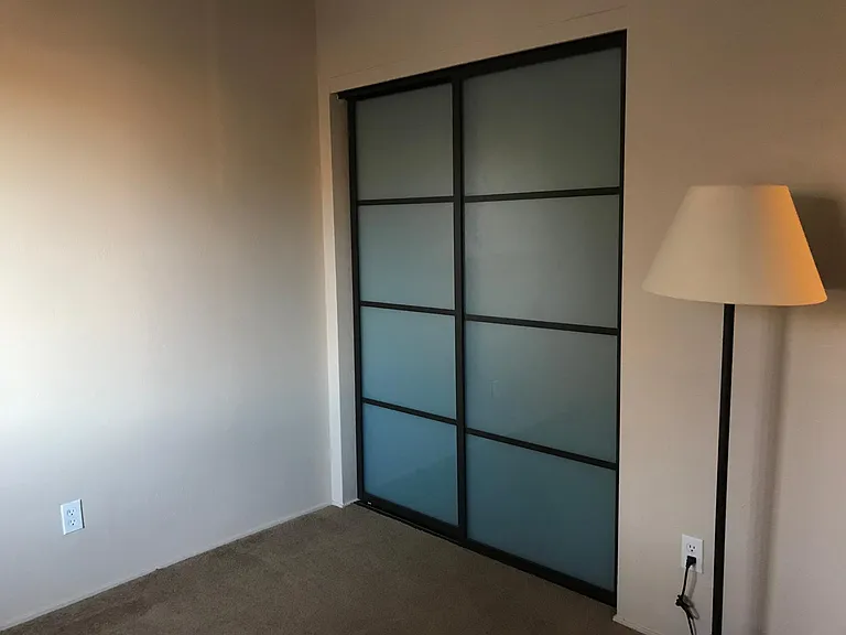 Office with frosted glass doors and mountain view.