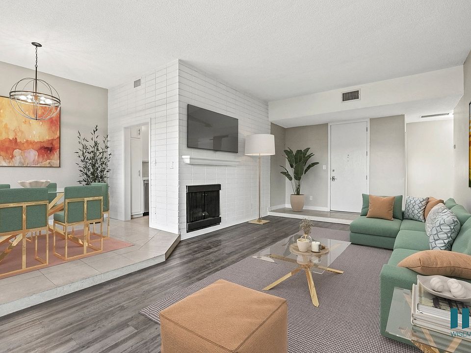 Open-Concept Dining and Living Room Area with Electric Fireplace