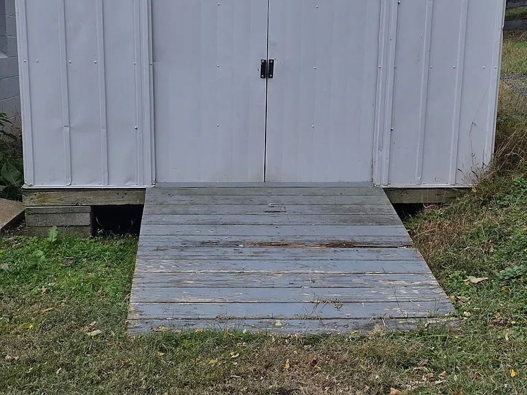 10 x 10 storage shed for lawn equipment and outdoor toys. Ramp provides easy access.