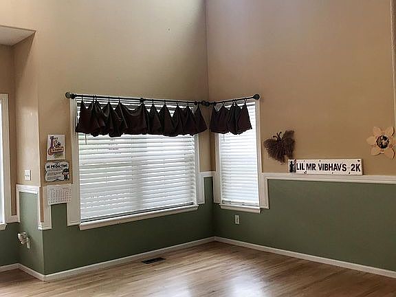 Well-lit formal living Space with vaulted ceiling