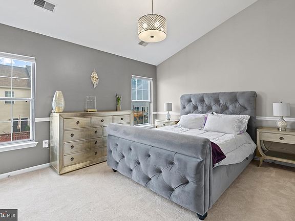 Primary with an ensuite bathroom and a walk-in closet