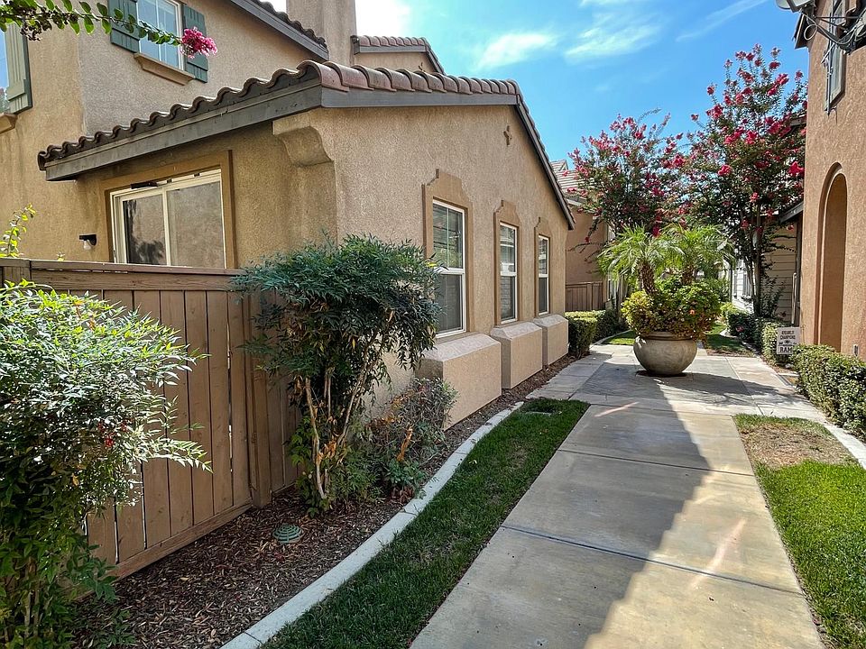 Warm inviting entrance. Well placed greenery and planters maintained regularly by HOA.
