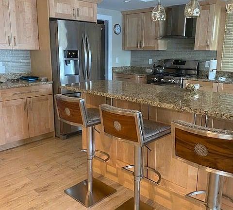 Fully equipped kitchen with 3 bar stools, gas stove, refrigerator with ice maker, dishwasher and disposal