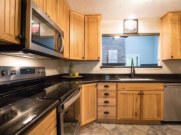 Through the dining room you will find the custom kitchen cabinets, open the doors and you will find some additional custom features.
