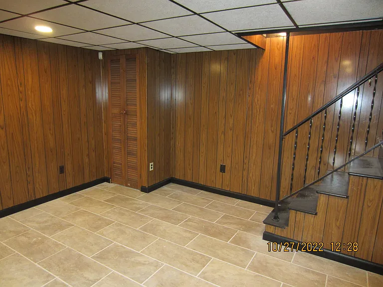 Informal living area- has enough room for easy living furniture, media, games and maybe a pool table? Its up to you how you would like to use this large open room. Stairway leads up to the dining room.