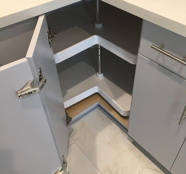 View of the interior of the bottom cabinets that features a lazy suzy.