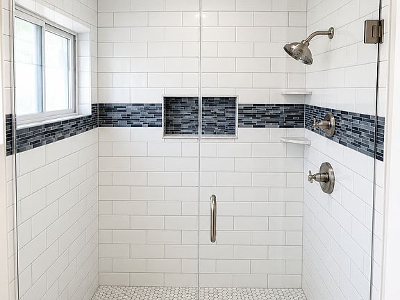 Dual valve shower in Primary Bathroom with custom glass enclosure