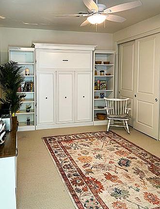 A very spacious daytime view with the Murphy bed in it's upright position with a controlled fan fixture that moves the air when needed. A very comfortable cushioned rocking chair is provided for your comfort.