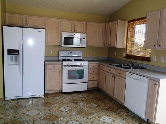Kitchen - side by side refrigerator, gas range, microwave, dishwasher, garbage disposal