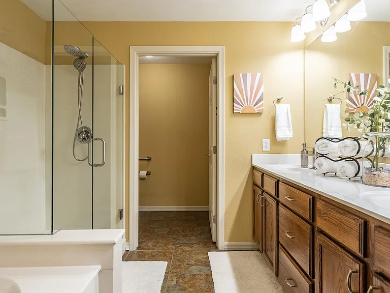 Primary bath with double sinks, walk in shower, garden soaking tub, private toilet room