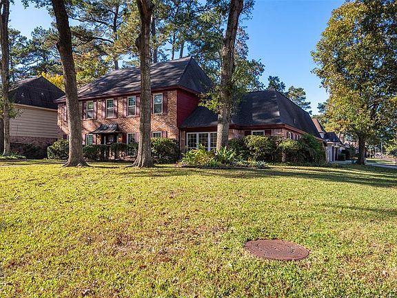 The large corner lot accommodates space for a side entrance as well, allowing access to the home and to the attached 2-car garage.
